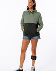 Woman wearing Sage Colorblock Hoodie. Text reads "Michelle is 5'10" wearing a size M".