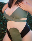 Closeup of woman wearing Olive elastic ostomy bag cover