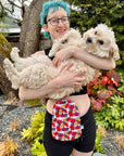 Woman wearing Hibiscus elastic ostomy bag cover holding dog