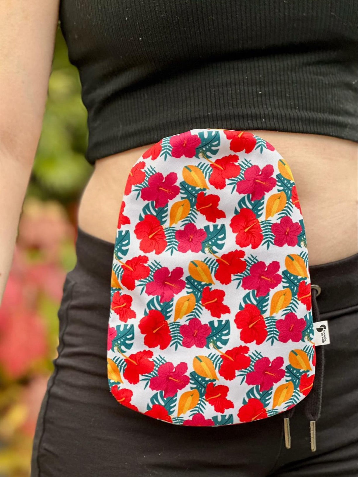 Woman wearing Hibiscus elastic ostomy bag cover