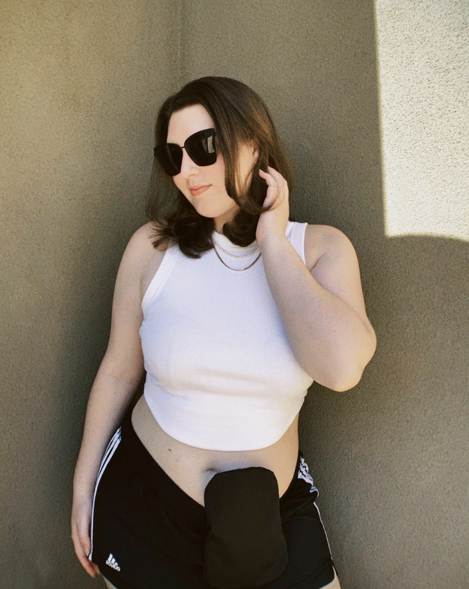 Woman wearing black elastic ostomy bag cover