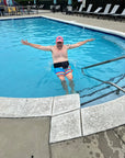 Man in pool wearing Elastic Ostomy Wrap Support belt
