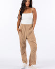 Woman wearing Khaki Felt Zip Access Pants with undone ankle zipper