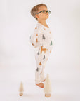 Boy standing in Thru the Trees G-Tube Pajamas with mini tree decorations