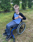 Boy in wheelchair wearing Adult Raglan Chemo Port Access Tee Shirt