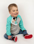 Boy in Kids Teal Raglan Access Tee with chest port
