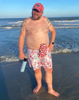 Man on beach wearing Hibiscus elastic ostomy bag cover
