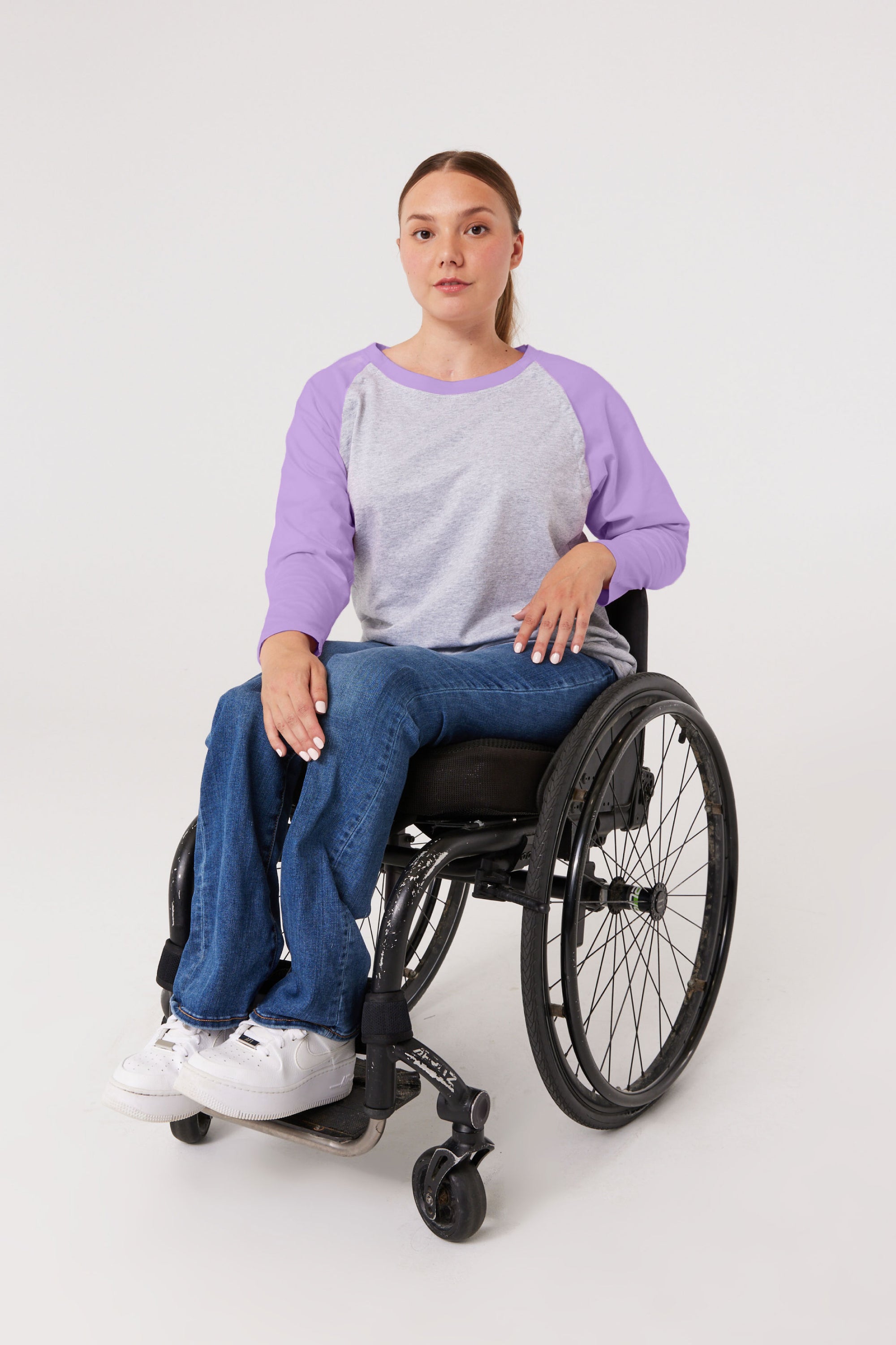 Woman in wheelchair wearing purple Raglan Access Tee