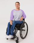 Woman in wheelchair wearing purple Raglan Access Tee