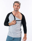 Male model unsnapping chest snaps on Black Raglan Access Tee