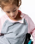 Gracie showing open snaps on Raglan Access Tee