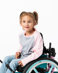 Gracie wearing Pink Raglan Access Tee in wheelchair
