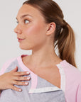 Woman wearing pink RAT showing chest snaps