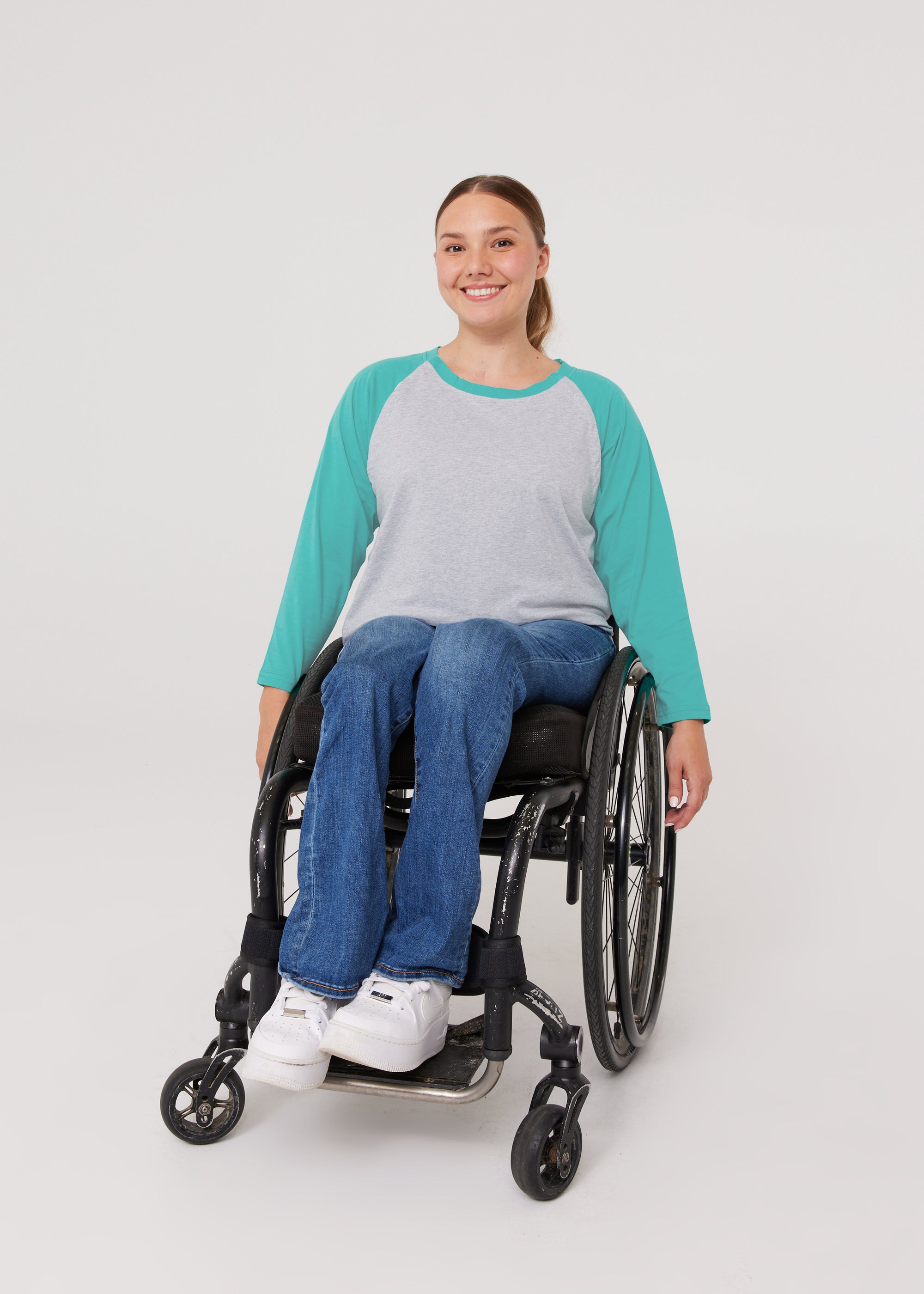 Woman in wheelchair wearing Teal Adult Raglan Chemo Port Access Tee Shirt