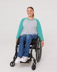 Woman in wheelchair wearing Teal Adult Raglan Chemo Port Access Tee Shirt