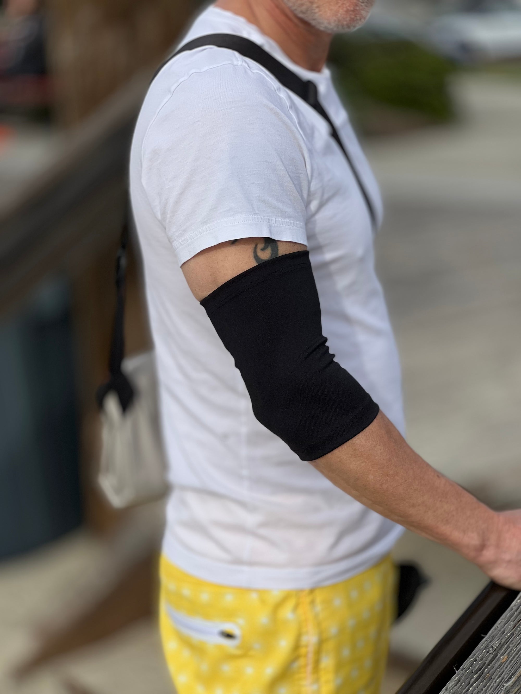 Man outside wearing black support sleeve