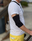 Man outside wearing black support sleeve