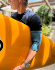 Man with surfboard wearing heathered support sleeve