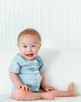 Boy in blue short sleeve all access bodysuit