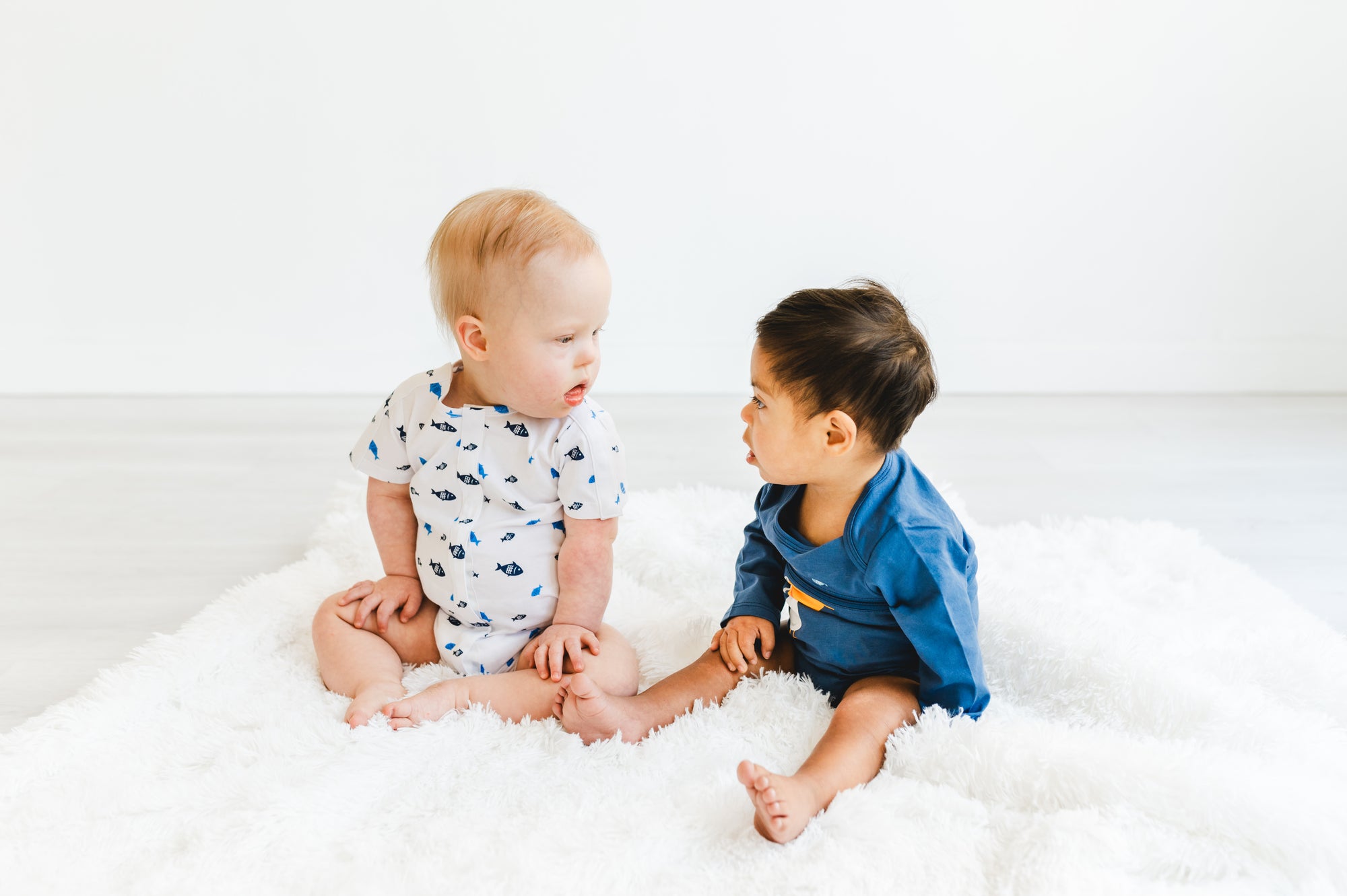 Two boys in adaptive bodysuits
