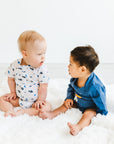Two boys in adaptive bodysuits