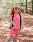Girl in pink Tummy Access Bodysuit