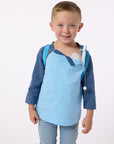 Finley wearing blue CB Kids Raglan Access Tee with open snaps, showing chest port