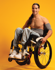 Man in wheelchair wearing gray support sleeve and waistband