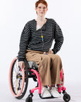 Woman in wheelchair with open chest zipper