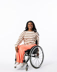 Denisha posing in Sunset Longsleeve Yarn-dye Zip Chest Access Tee in wheelchair