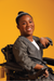 Woman in wheelchair wearing black Adult Chest Access Chambray Wrap Top