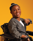 Woman in wheelchair wearing black Adult Chest Access Chambray Wrap Top