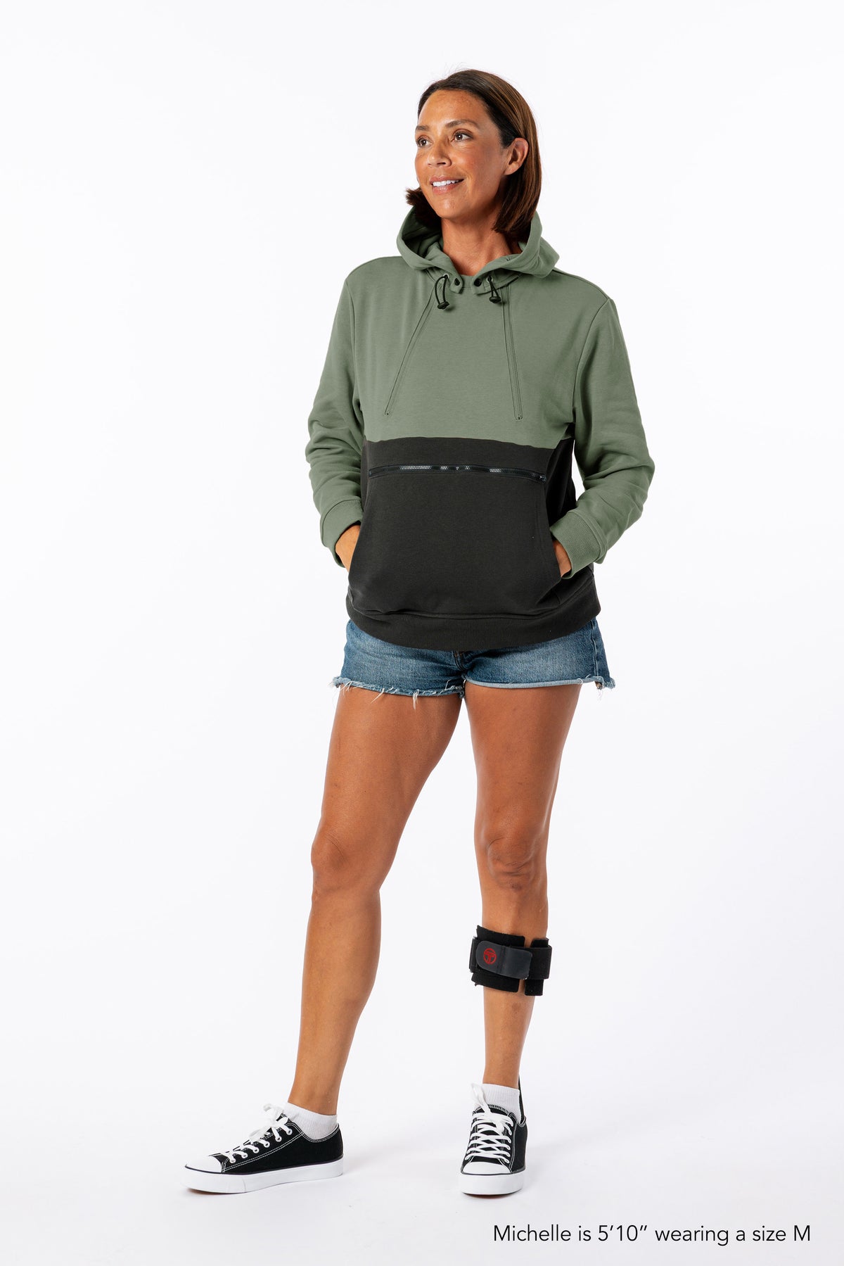 Woman wearing Sage Colorblock Hoodie. Text reads "Michelle is 5'10" wearing a size M".