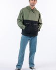 Man wearing Sage colorblock hoodie against white background. Text reads "Reed is 5'9 1/2" wearing a size M".