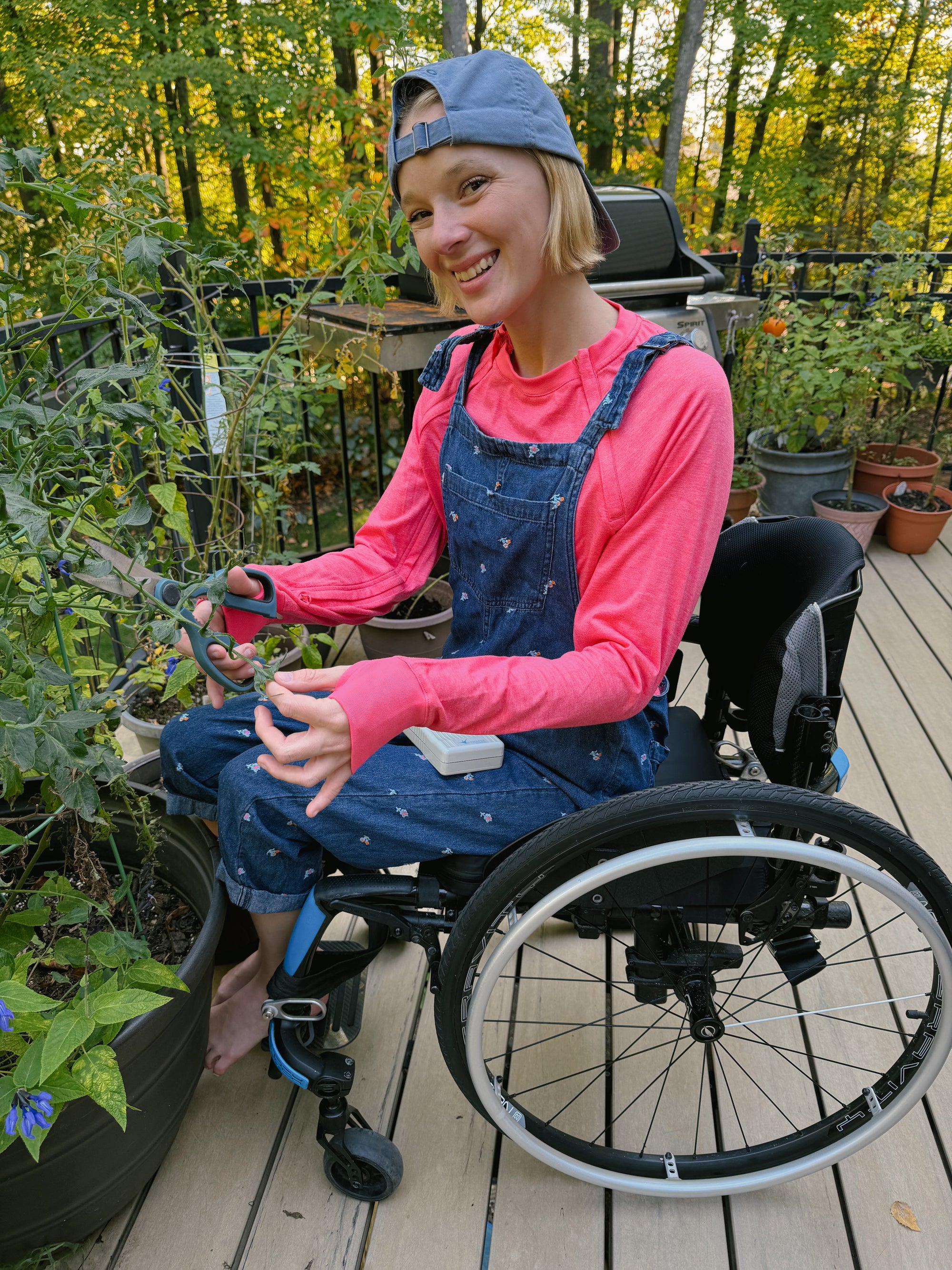 Cienna Ditri in Sunset Raglan Arm Zip Access LS Tee outside in garden