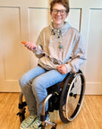 Man in wheelchair wearing Zipper Access Hoodie, showcasing feeding tube access from Spoonie Signature Pocket