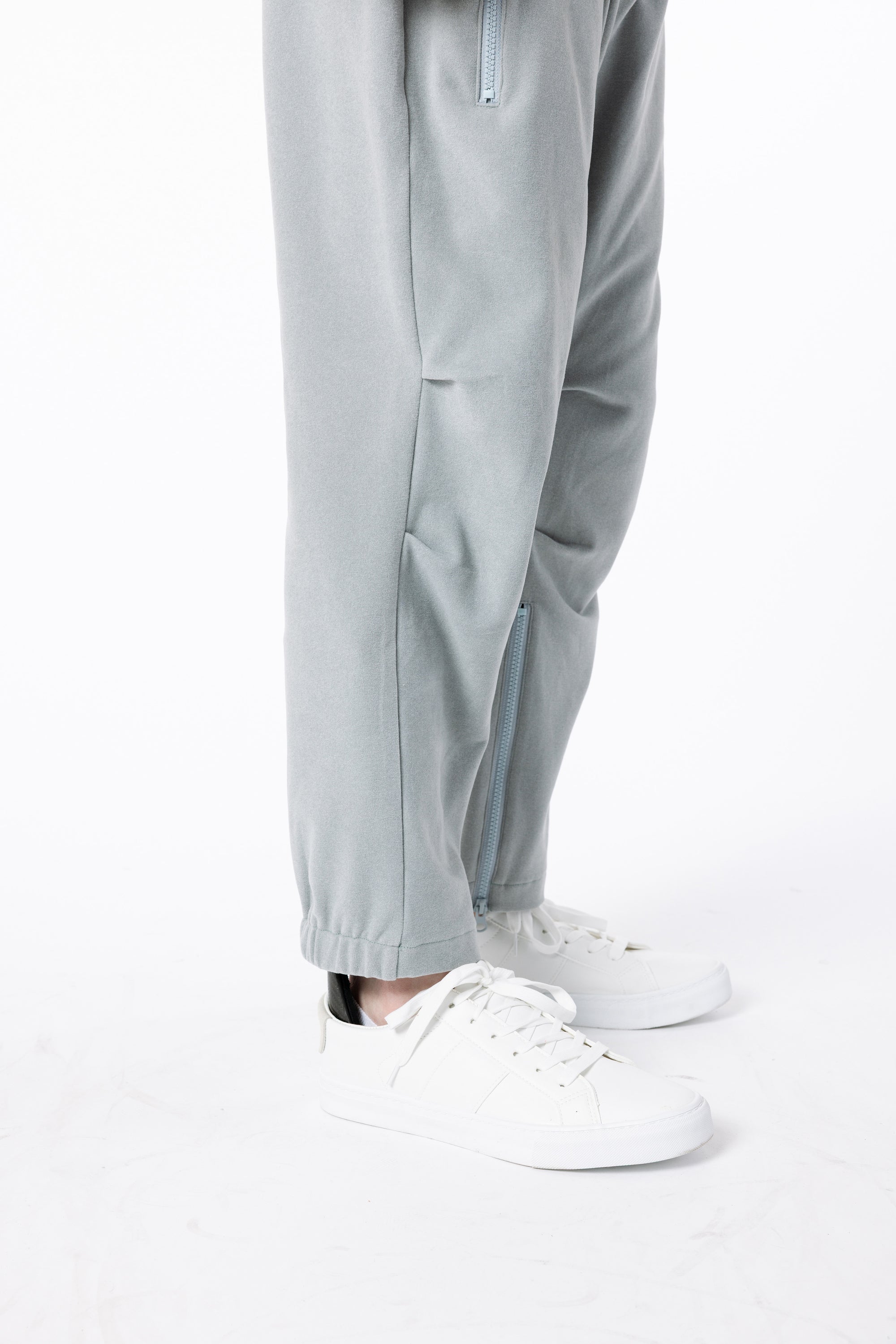 Closeup of person wearing Stone Felt Zip Access Pant