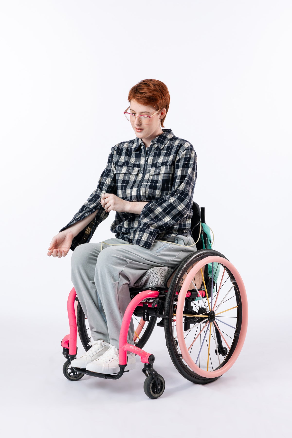 Woman in wheelchair wearing Denim Shacket unzipping arm zipper