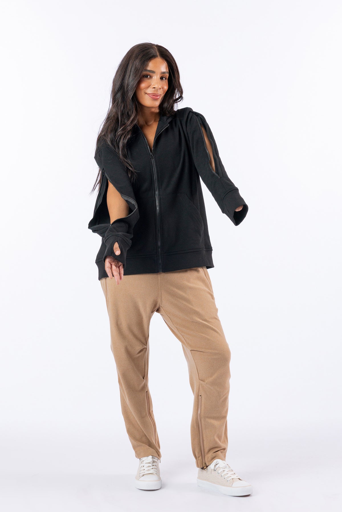 Celia showing arm access on both sides of Full Zip Hoodie