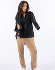 Celia showing arm access on both sides of Full Zip Hoodie