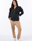 Woman wearing Full Zip Hoodie and Felt Zip Pants. Text reads "Celia is 5'4" wearing a size M".