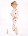 Boy standing in Thru the Trees G-Tube Pajamas with mini tree decorations