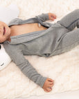 Child wearing open Heather Gray Rib G-Tube Pajamas lying down