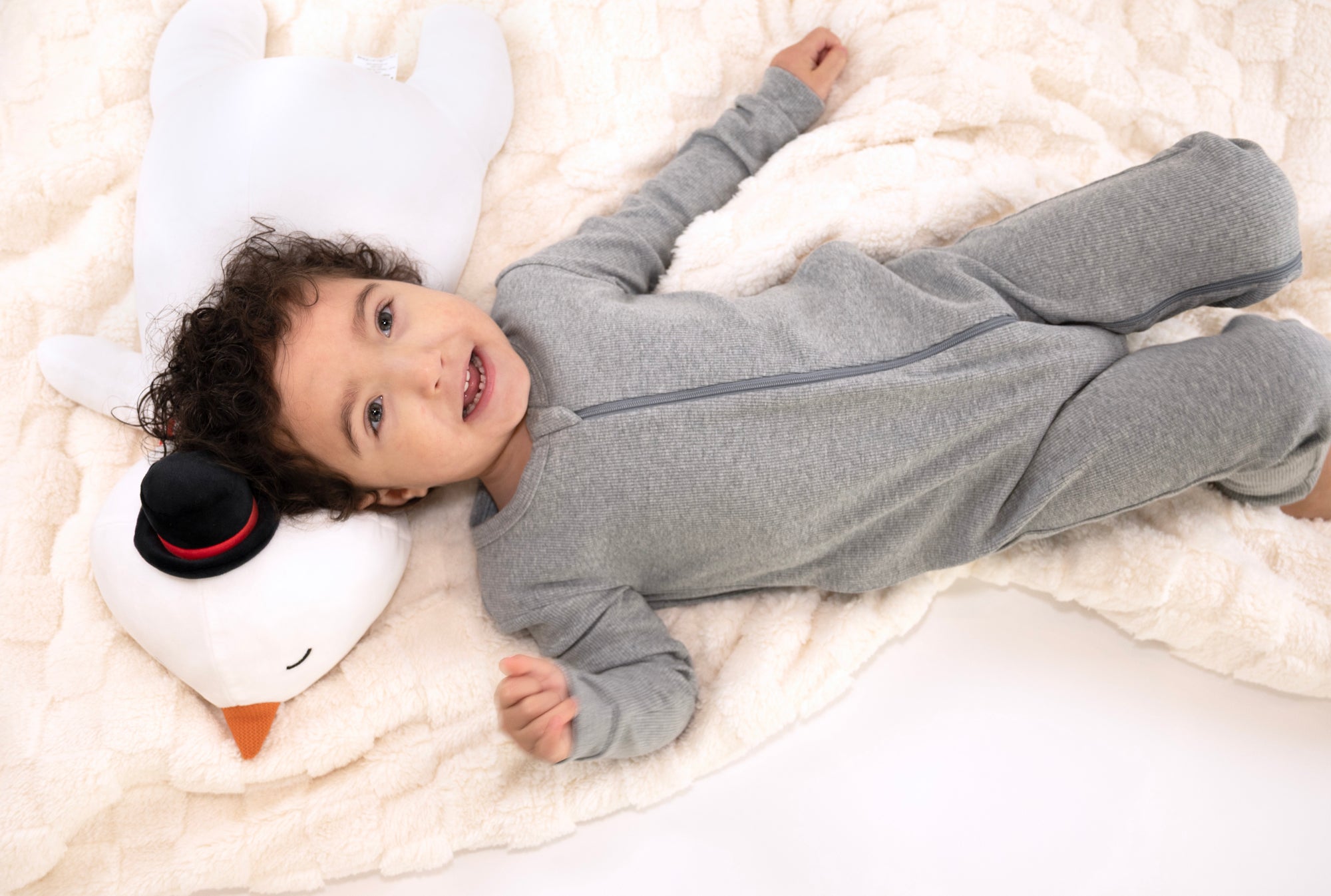 Child wearing Heather Gray Rib G-Tube Pajamas lying down