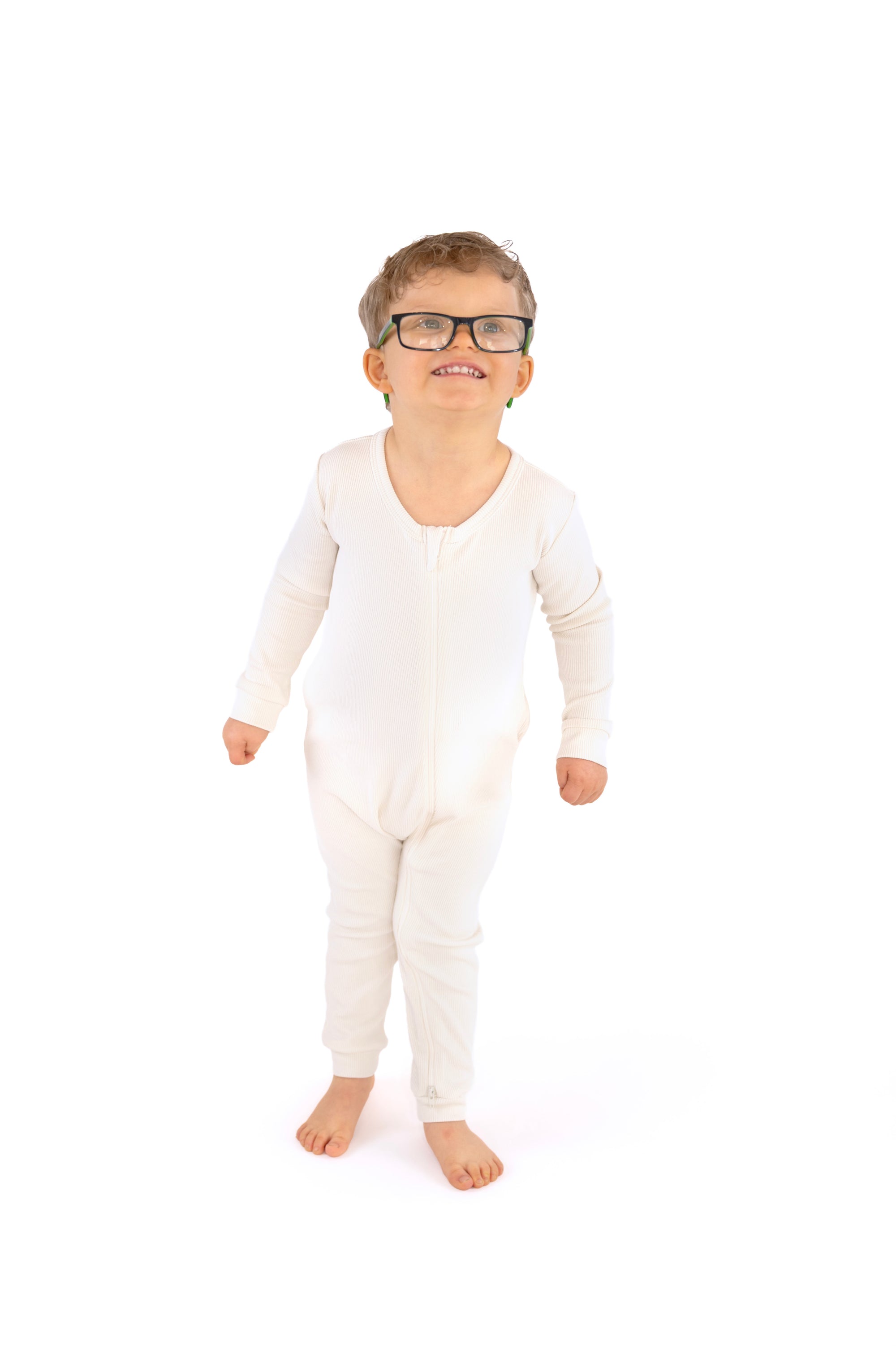 Child wearing a white pajamas and glasses on a white background