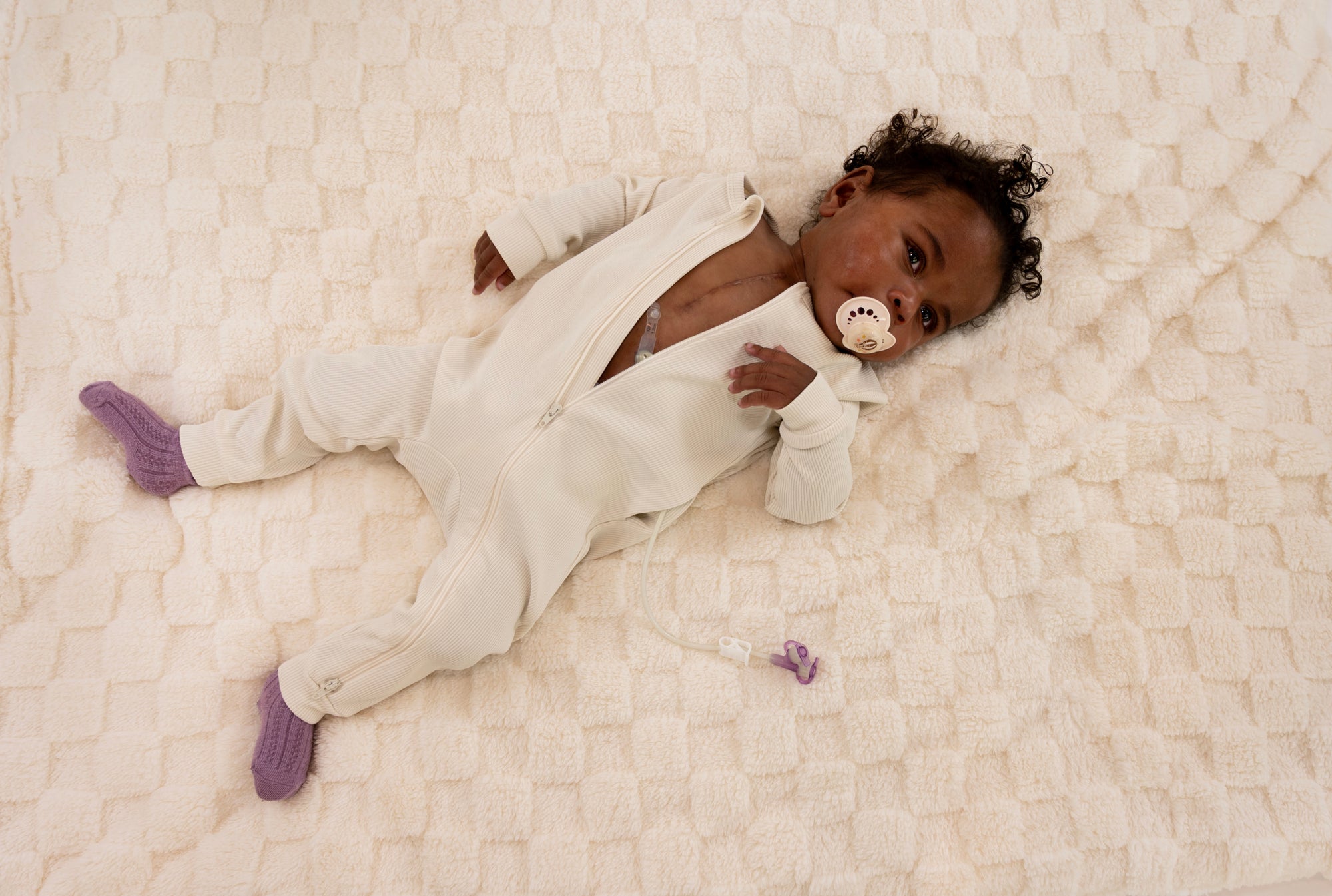 Baby in Vintage White Rib G-Tube Pajamas with G-Tube showing
