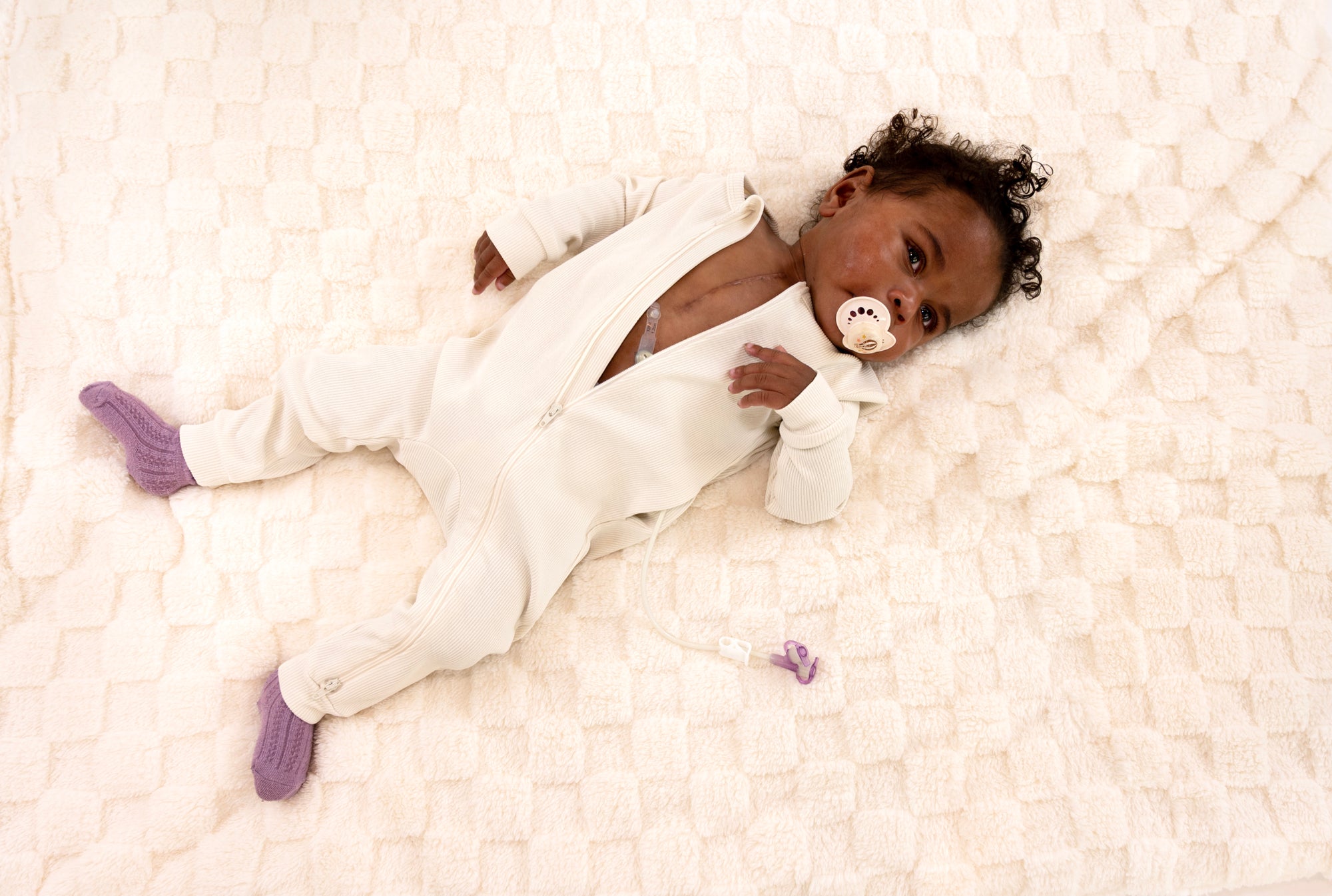 Baby in Vintage White Rib G-Tube Pajamas with G-Tube showing