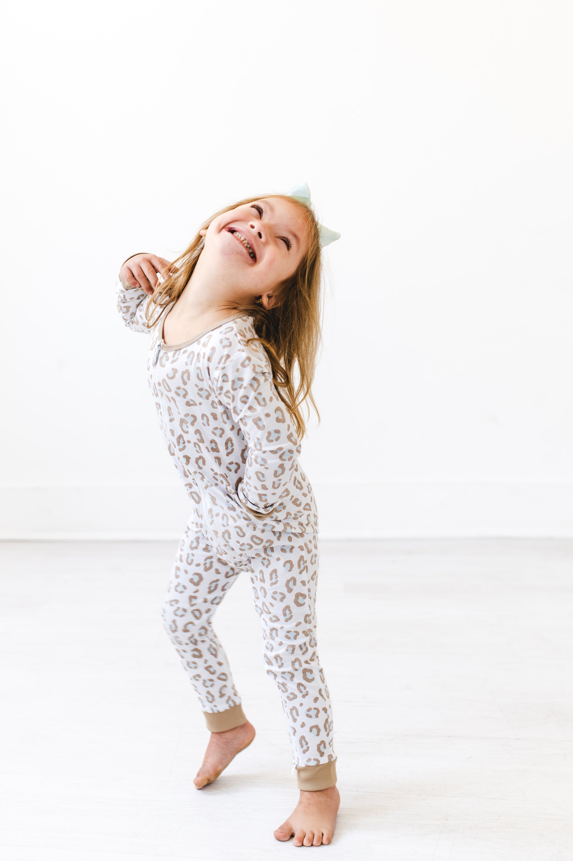 Girl in leopard print gtube pajamas