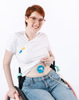 Woman in wheelchair wearing aqua G-Tube Pad