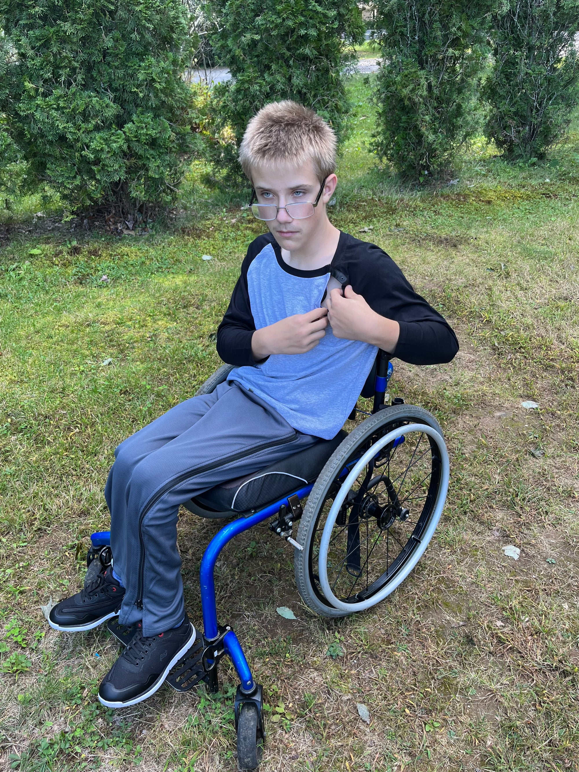 Boy in wheelchair wearing Adult Raglan Chemo Port Access Tee Shirt